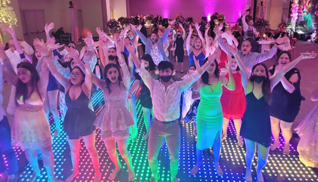 School dance floor under colored lights.